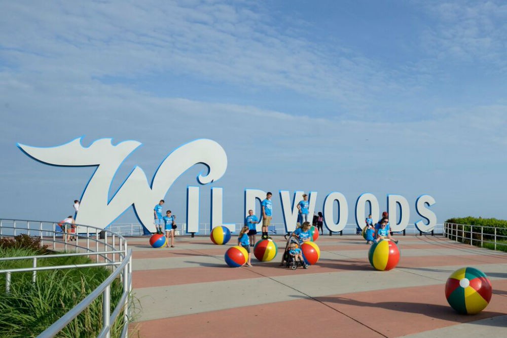 Many large family groups seeking a budget-friendly vacation choose Wildwood—including this group posing at one of the beachfront landmarks.