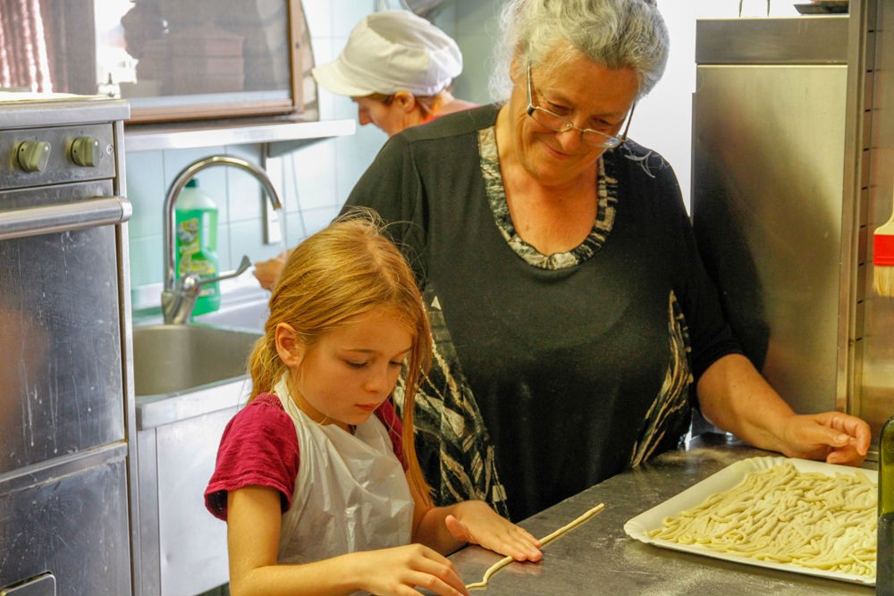 My daughter making pici pasta at Boscarecce Cooking School.