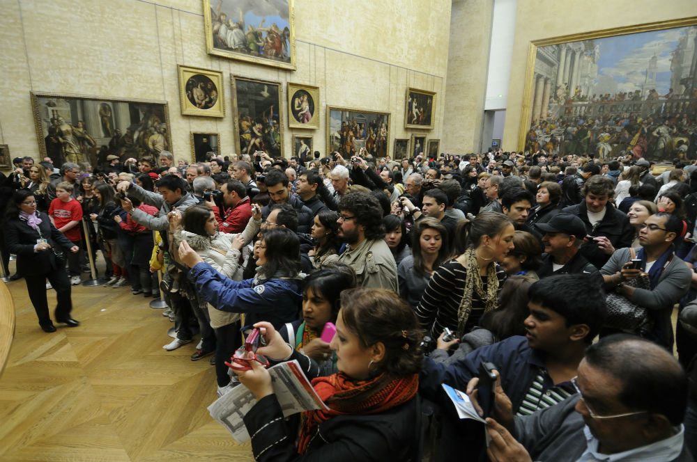 crowd in front of the Mona Lisa at the Louvre Paris France