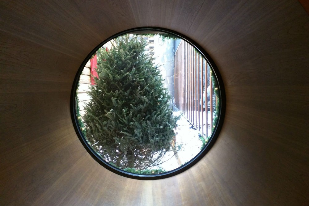 A view through a circular window onto the fake outdoor winter scene, Dream Downtown. Photo: Billie Cohen