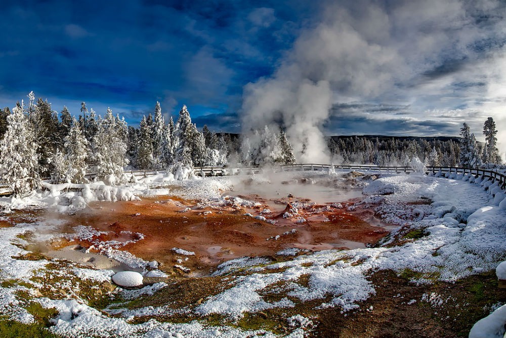 snowy scene of hot spring steaming in winter in Yellowstone National Park
