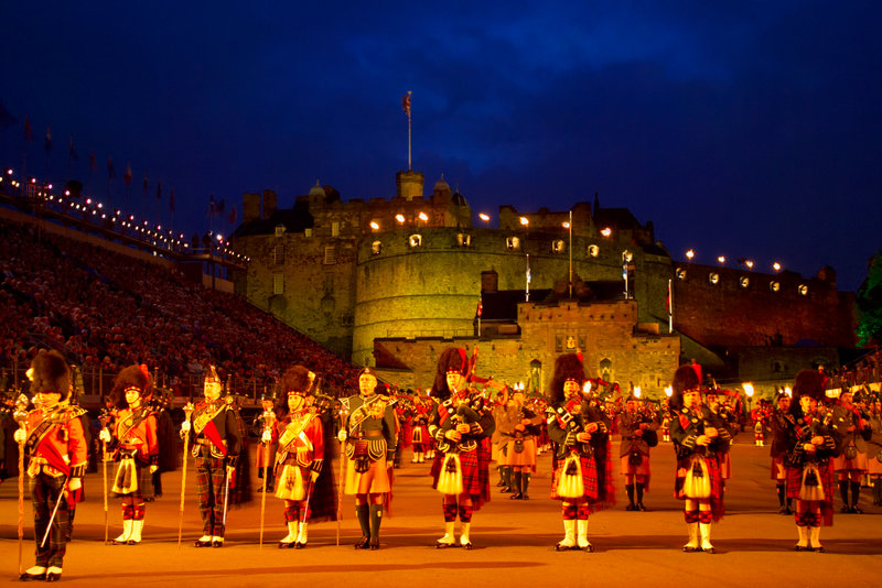 Piper bands on parade in the Castle's torch-lit esplanade during the Edinburgh Military Tattoo