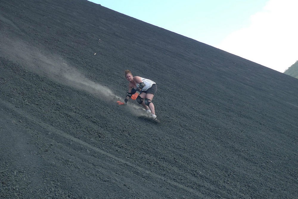 woman sandboarding down the Cerro Negro volcano