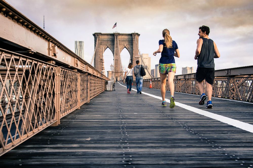 joggers on Brooklyn Bridge New York 