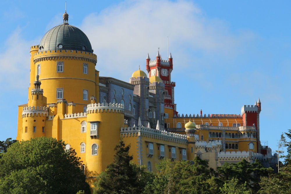 the colorful yellow and red turrets of Pena Palace, Sintra, Portugal