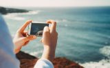 smartphone taking picture ocean beach