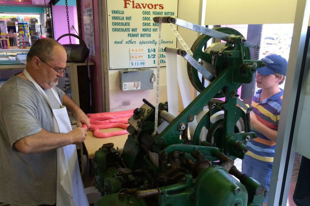 You can see salt water taffy being made—and fed into a 62-year-old taffy-wrapping machine.