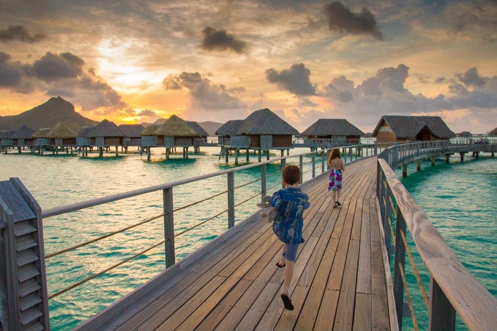 My kids running to dinner at the Four Seasons Bora Bora.