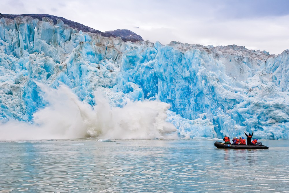 Guests explore on Zodiac in Southeast Alaska, Tracy Arm, calving ice