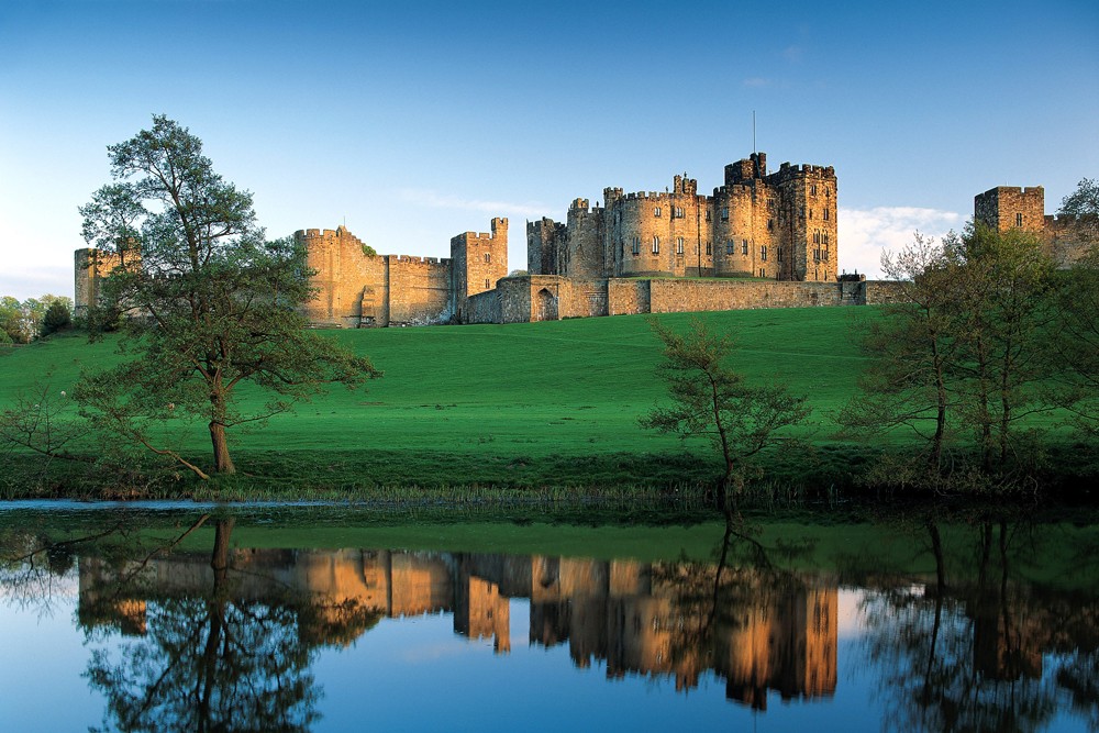 Alnwick Castle reflected in the river. England UK