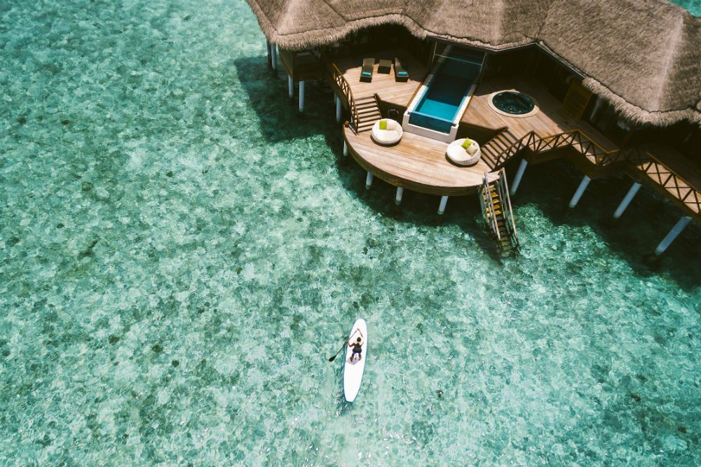 aerial view of an overwater bungalow at Huvafen Fushi in the Maldives