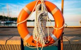 orange life preserver on hook at lake