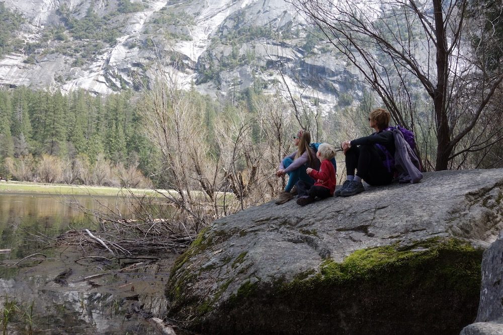 family resting at Mirror Lake in Yosemite national park