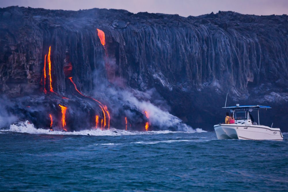 boat at shore dripping with lava, big island, hawaii