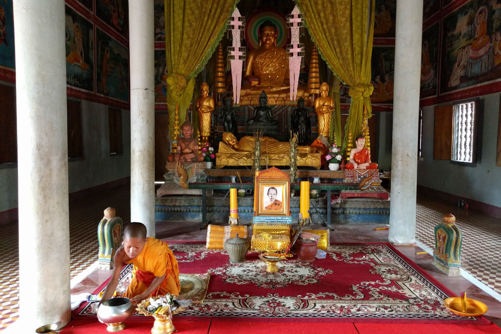 young monk prepares a water blessing at Phnom Krom Pagoda Cambodia