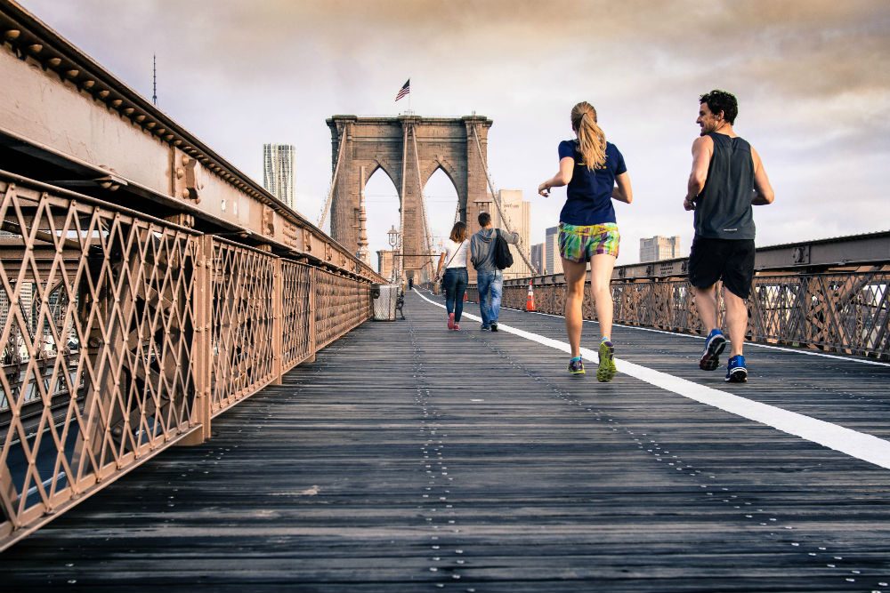 joggers on Brooklyn Bridge New York