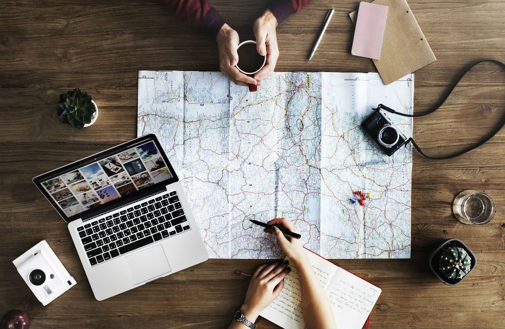 travel planning with map and laptop