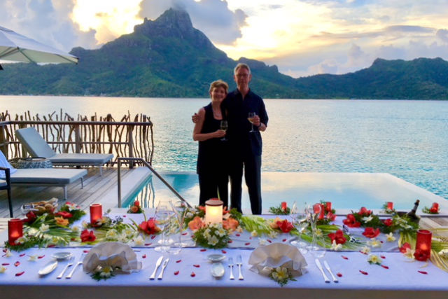 couple on overwater bungalow in bora bora