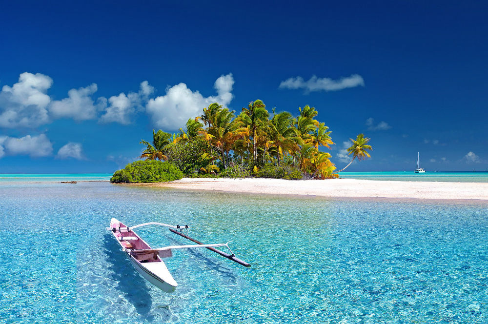 Fakarava island in french polynesia with canoe on turquoise blue water