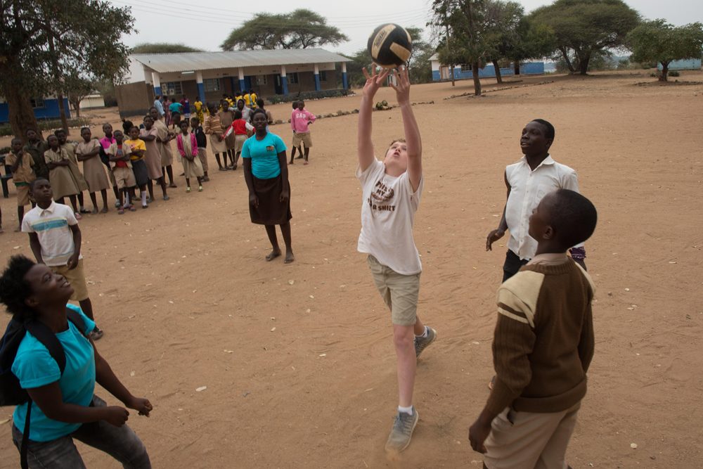 Doug plays with new friends in their schoolyard in Chiawa, Zambia.