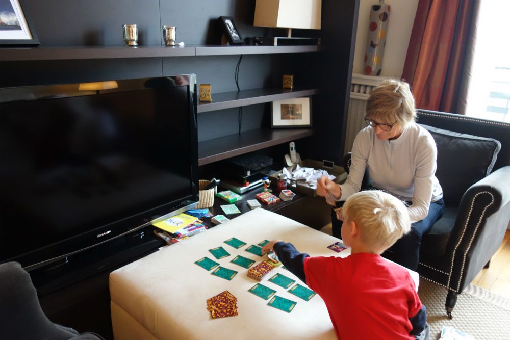 adult and child play cards in an apartment rental in Paris