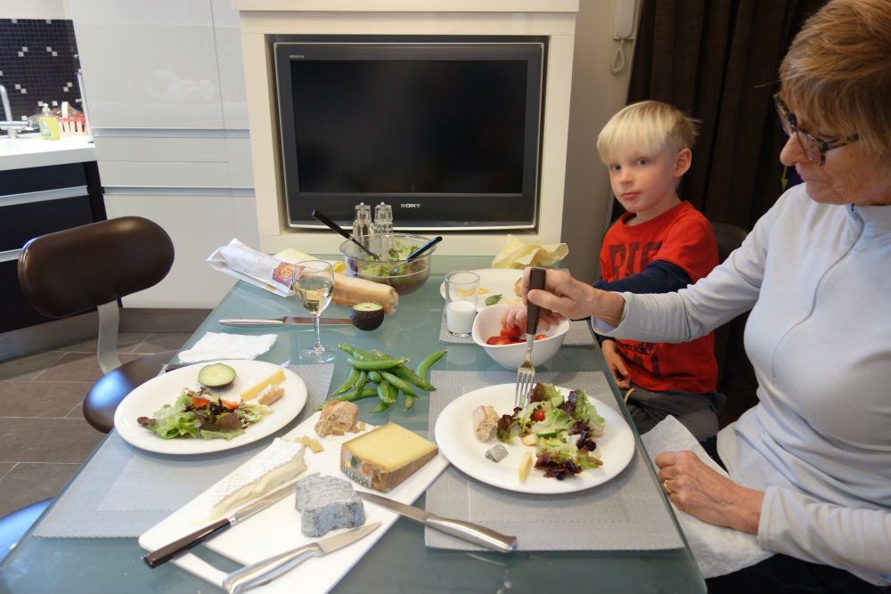 family in Paris rental apartment eating lunch