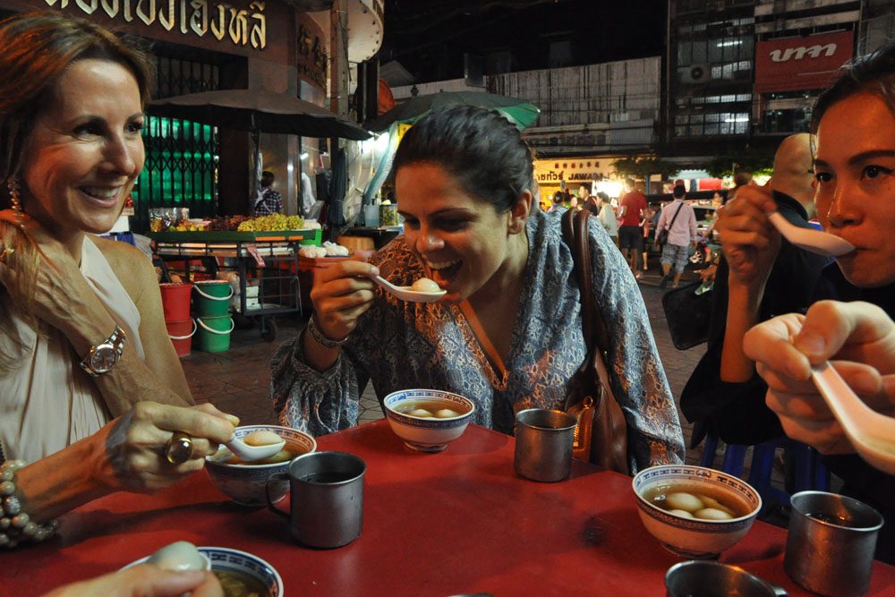 people eating street food in Bangkok, Thailand