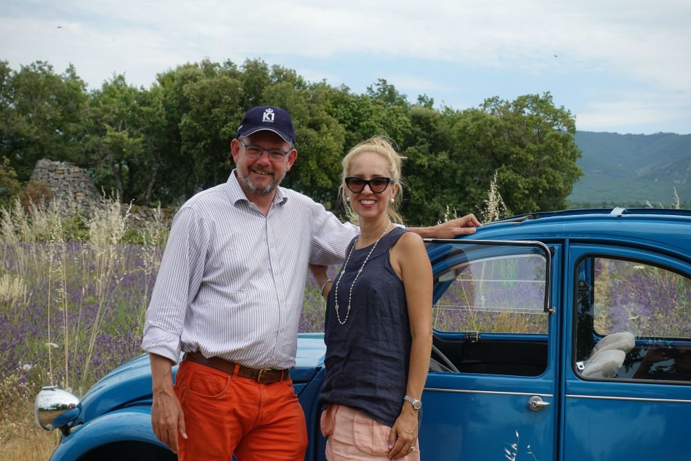 two people standing by a classic Citroën 2CV car in Provence lavender field