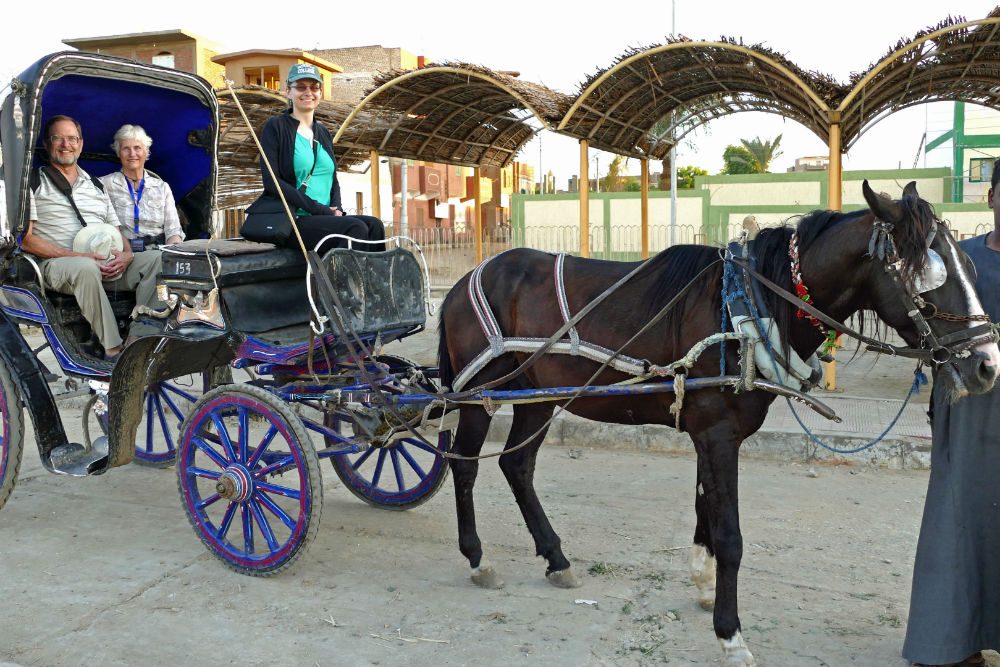 tourists taking a carriage to the Temple of Horus at Edfu Egypt