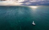 aerial shot of Belize ocean with sailboat