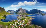 Reine, Lofoten, Norway. The village of Reine under a sunny, blue sky, with the typical rorbu houses. View from the top