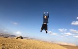 teenage boy jumping in Negev Desert Israel