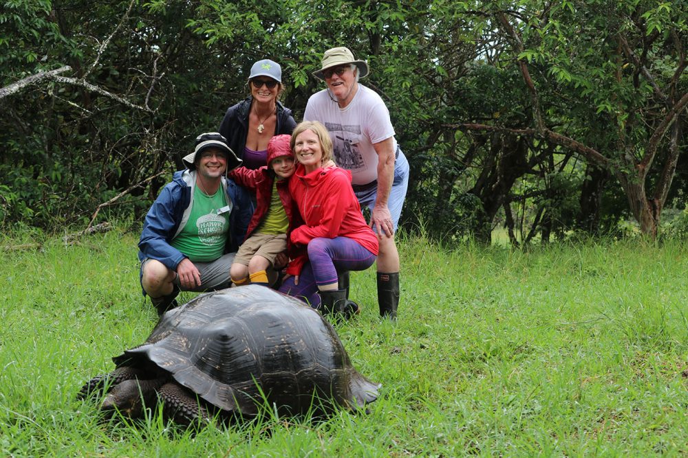 famiy with giant tortoise in the Galapagos