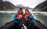 couple toasts with champagne in zodiac boat Endicott Arm Alaska
