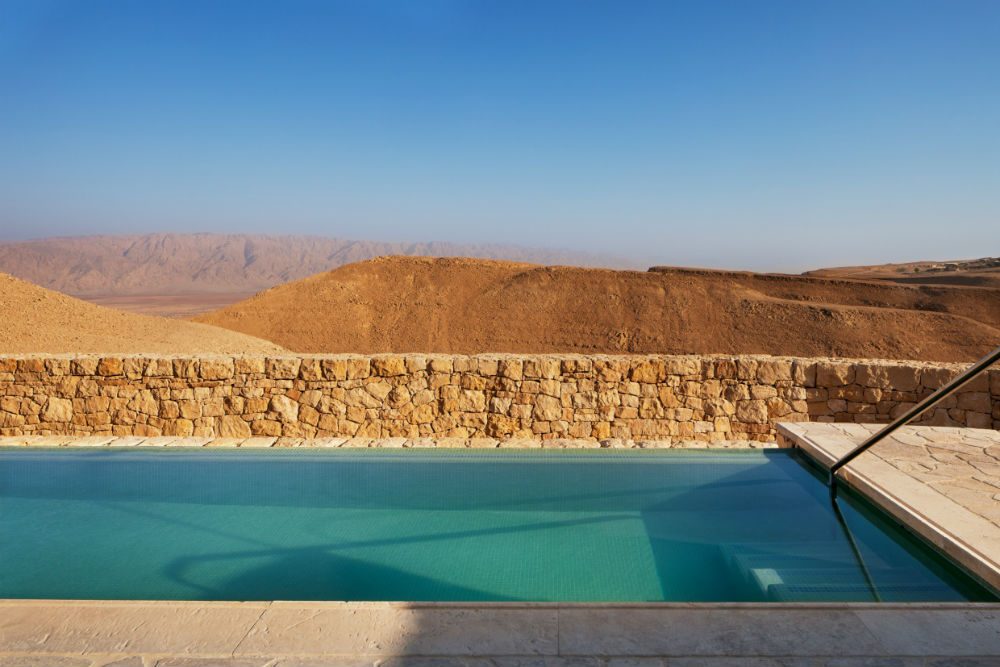 turquoise infinity pool looking out over the Negev desert at the Six Senses Shahurte