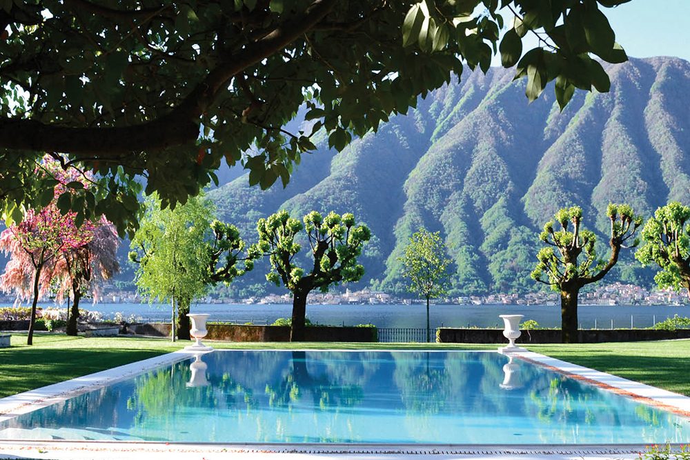 Pool view looking over the lake and mountains in Villa Balbiano, Lake Como, Italy.