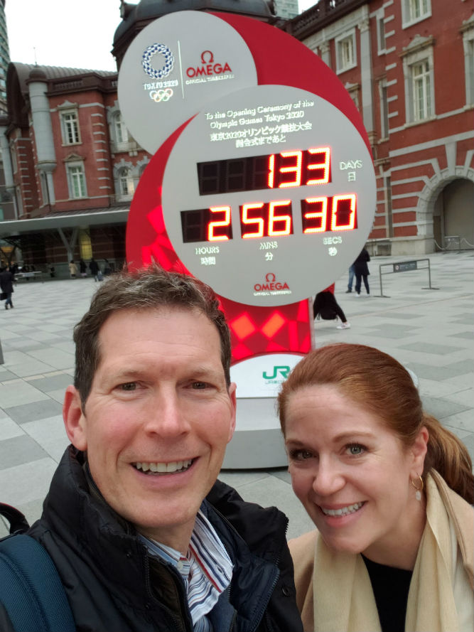 tourist couple selfie in front of countdown clock to Tokyo Olympics in Japan