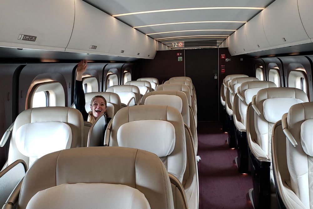 empty Shinkansen train in Japan with one traveler waving