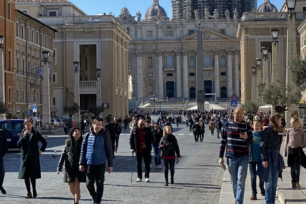 tourists walking in Rome in front of St Peters Basilica