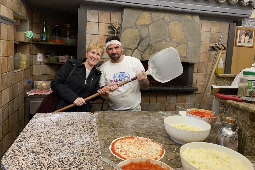 tourist with pizza maker in Rome Italy