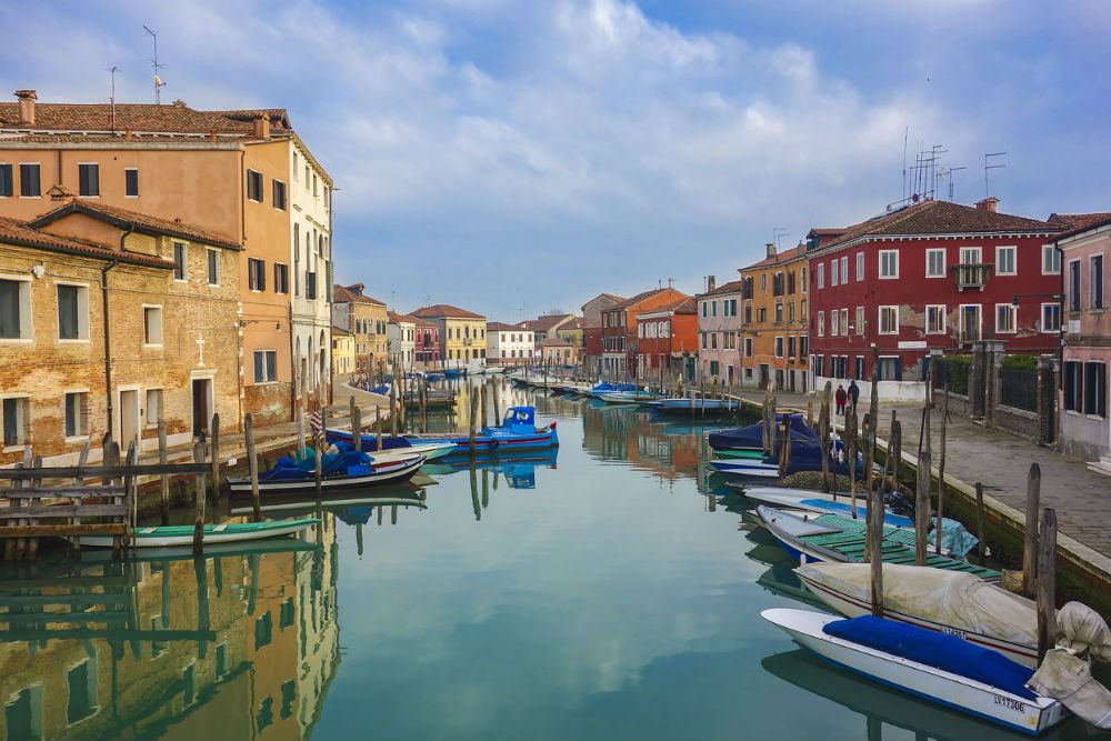 venice murano island canal with boats and no crowds