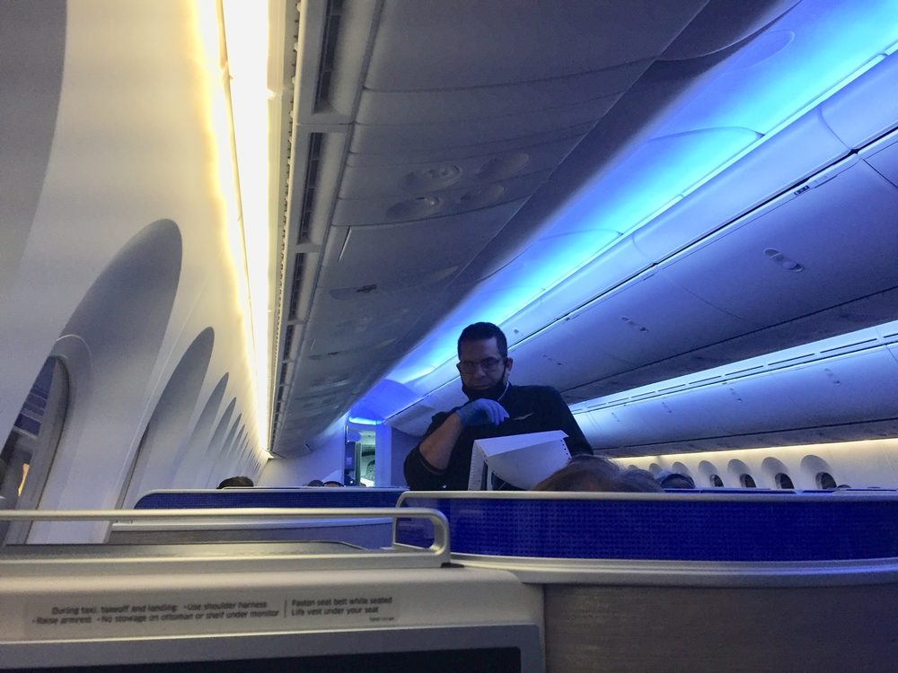 United flight crew attendant with mask around chin