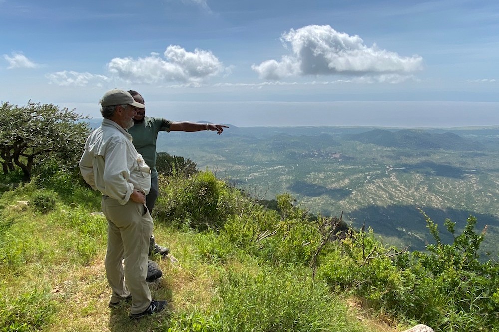 man and guide looking over view in Africa