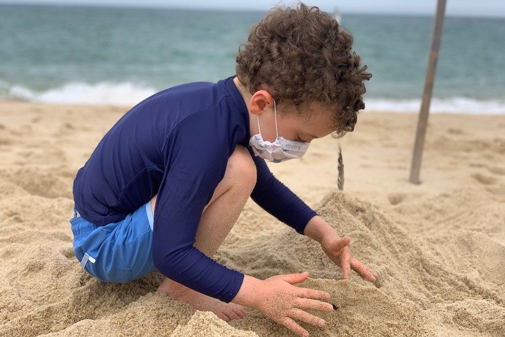 young boy Building sandcastles on the beach in Cape Cod