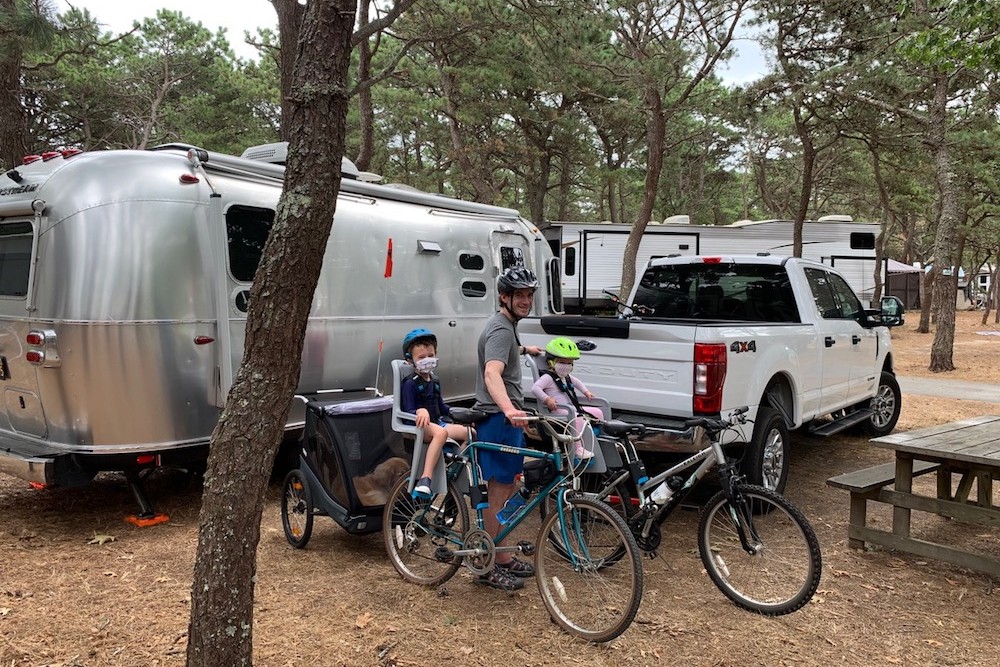 dad with kids on bikes in a RV campground