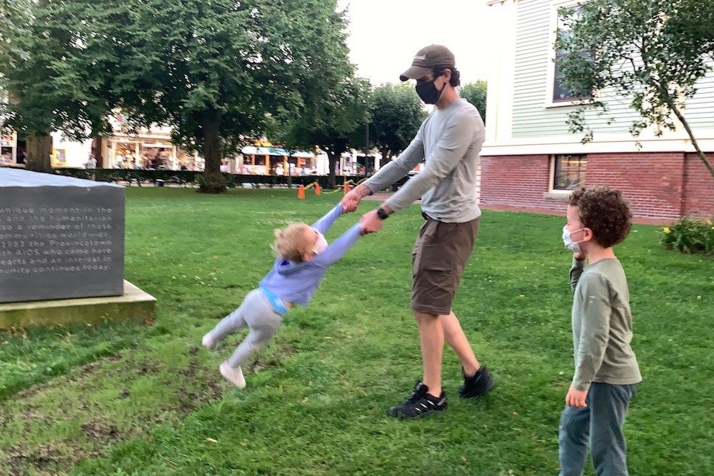 dad and kids playing in a park in Provincetown