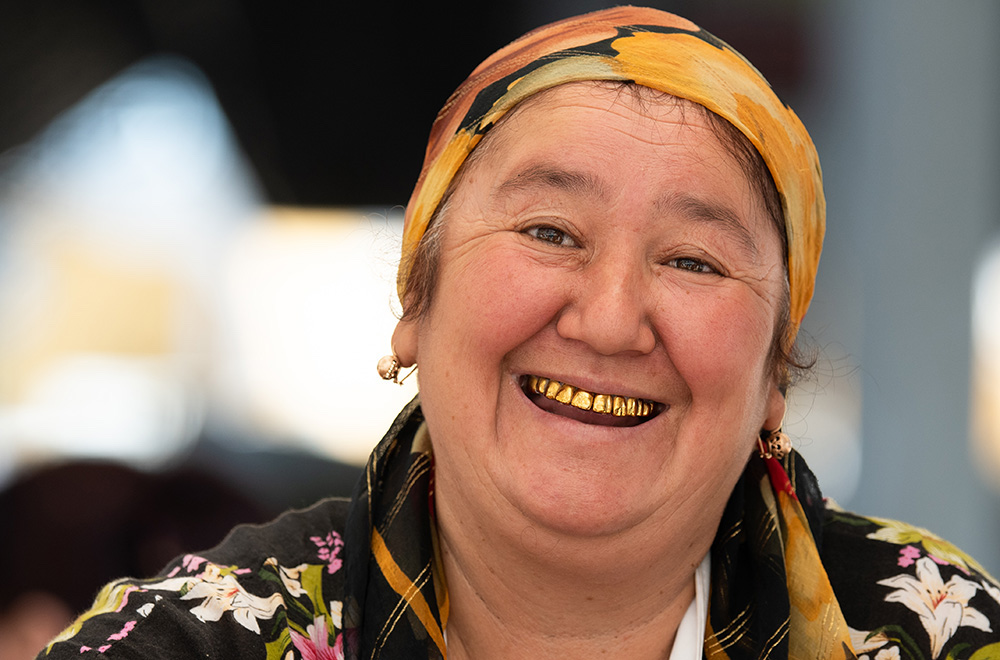 Uzbekistan old woman smiling with gold teeth