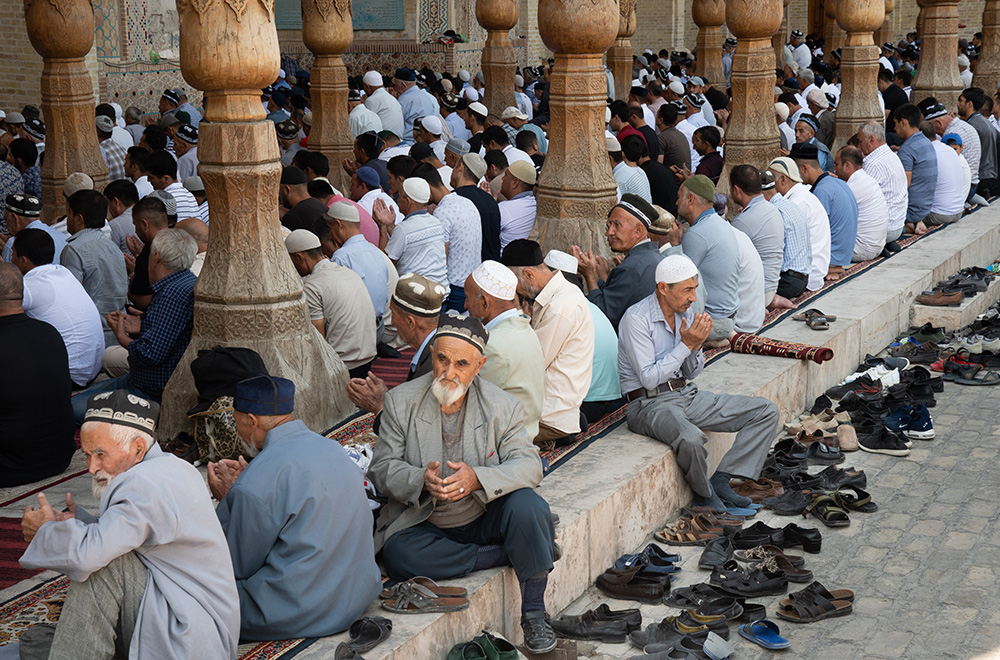 Uzbekistan men praying Bolo Hauz mosque in Bukhara