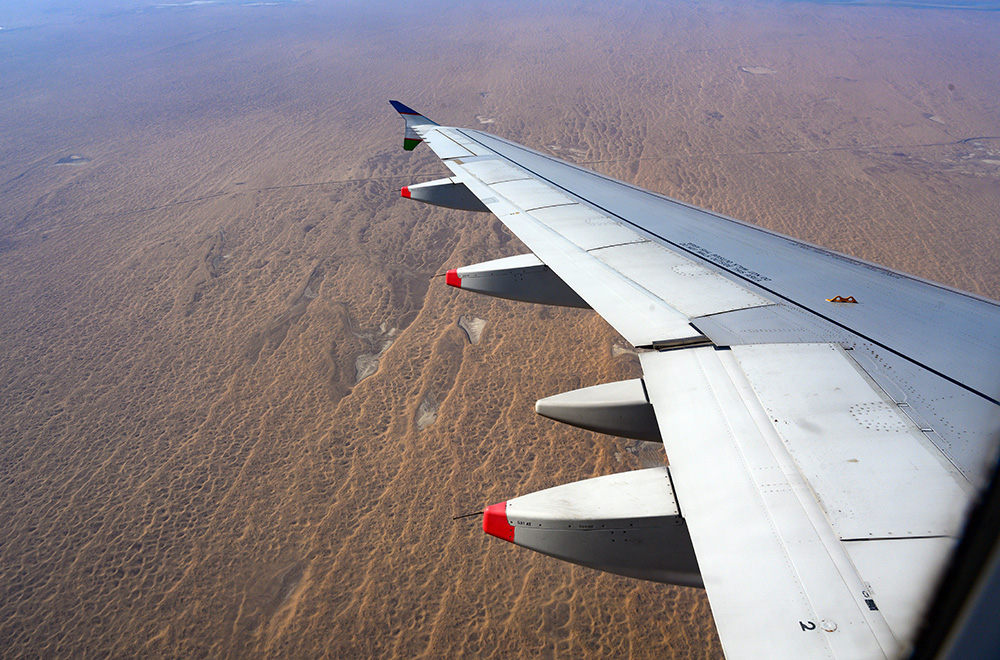 View from airplane flying from Tashkent to Urgench Uzbekistan over desert