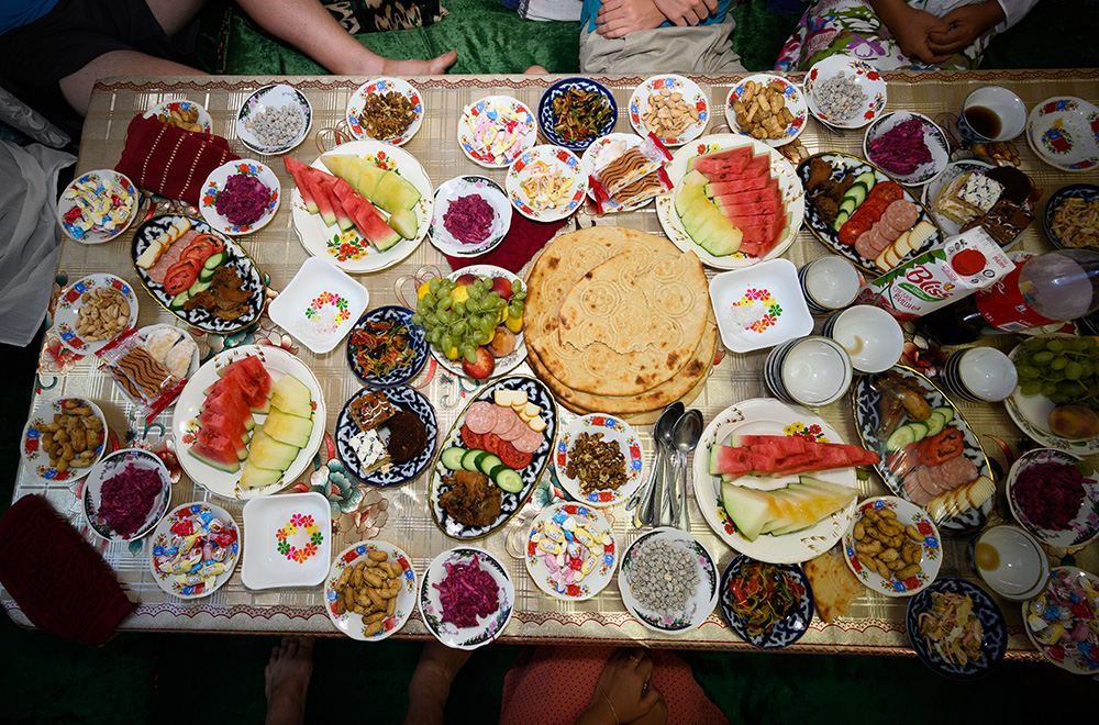 aerial photo of food at a familys table for a party in Uzbekistan